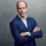 Meet the Team of experts - Photo of Akos Reger, person in business suit, smiling, male, gallantly, crossed arms