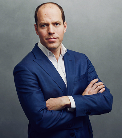 Meet the Team of experts - Photo of Akos Reger, person in business suit, smiling, male, gallantly, standing upright,crossed arms